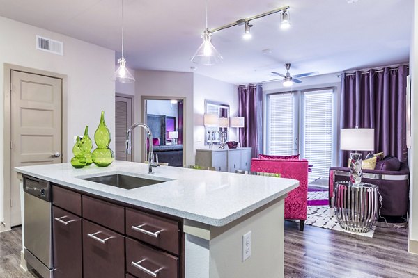 Bright kitchen with island, open living area, and vibrant decor in Platform Apartments, Seattle