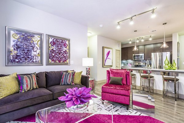 Bright living room with vibrant decor and open kitchen at Platform Apartments