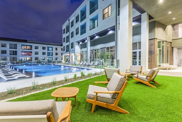 Platform Apartments: Luxury apartment complex with pool, outdoor seating, and green lawn in Greystar community
