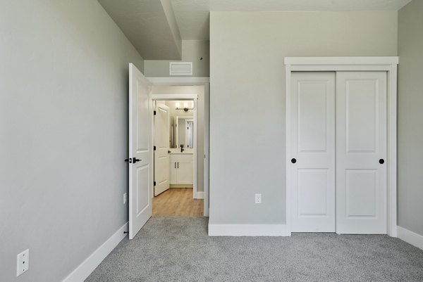 Cozy bedroom with modern furnishings at Rosewood Apartments