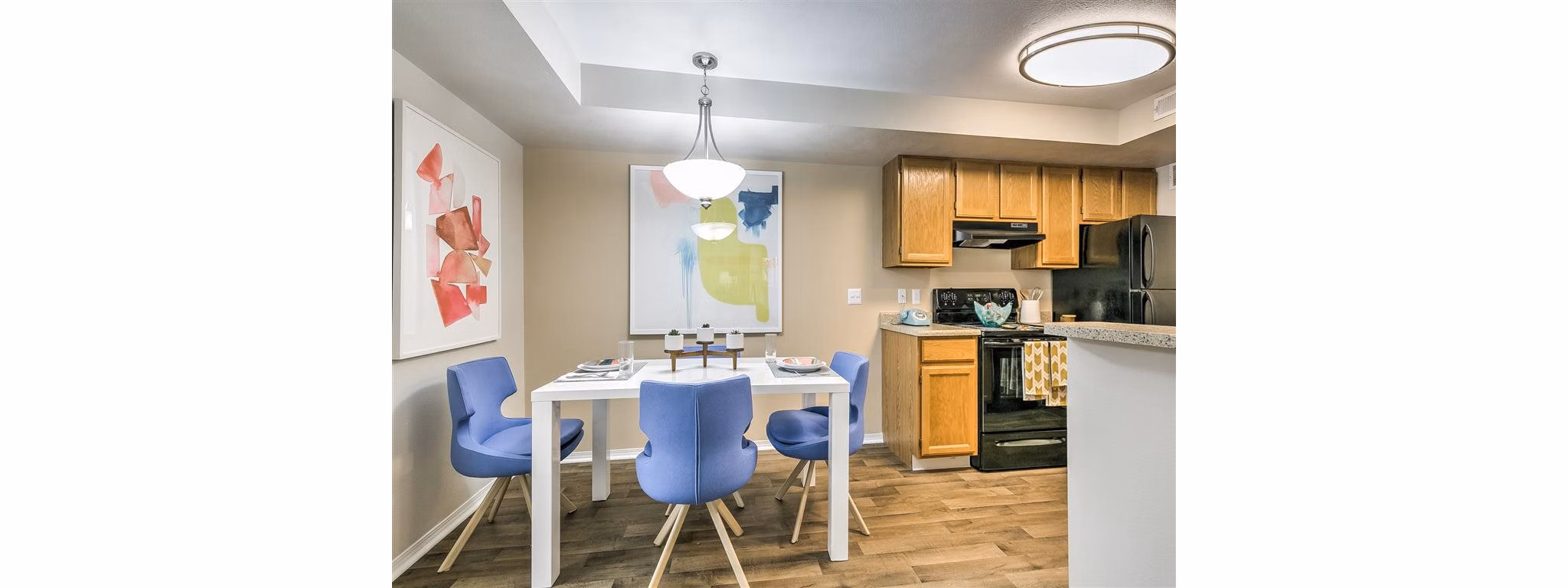 Dining room with elegant chandelier and modern furnishings at Rosewood Apartments