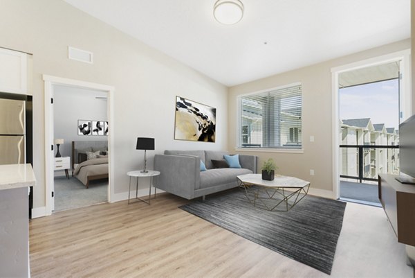 Contemporary living room with elegant furniture and natural light at Rosewood Apartments