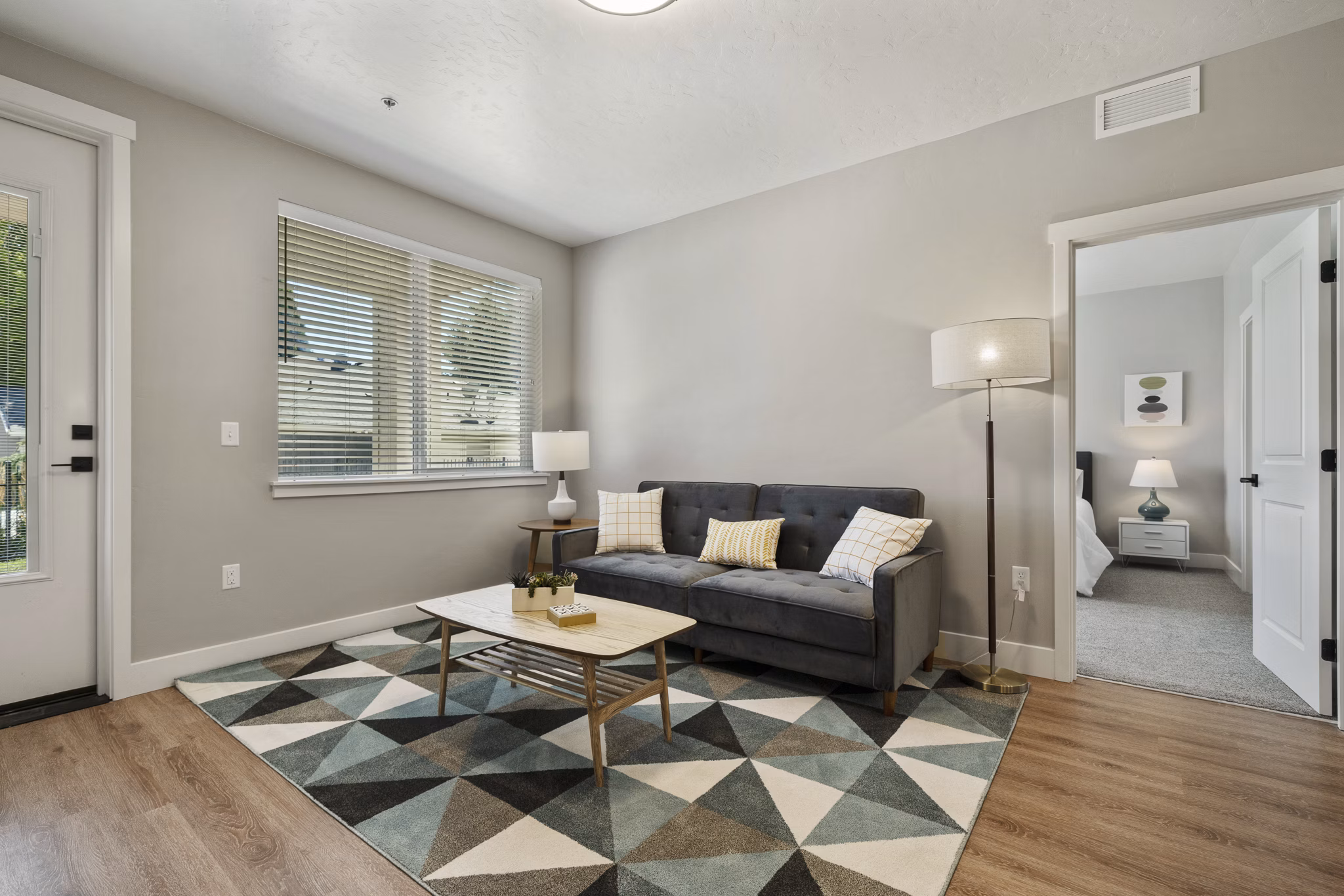 Contemporary living room with stylish decor and ample natural light at Rosewood Apartments