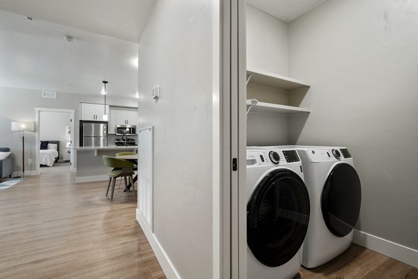 Laundry room featuring energy-efficient washers and dryers at Rosewood Apartments
