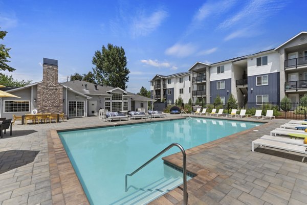 Luxury pool with lounge chairs at Rosewood Apartments, a premium Greystar community