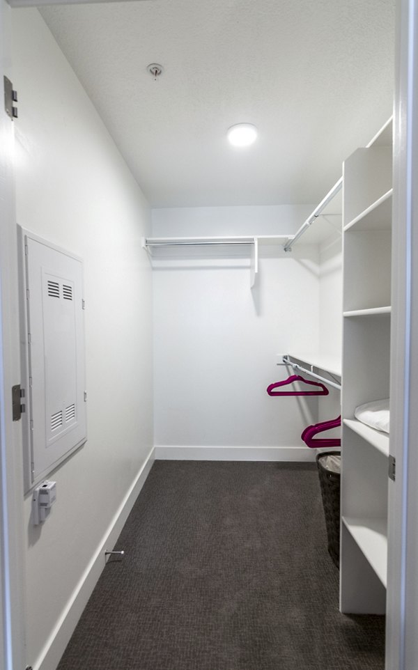 Organized bedroom closet with built-in shelving at 4th West Apartments, perfect for luxury living in the heart of the city
