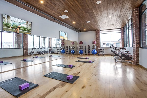 Yoga/spin studio with mirrored walls and ample space at 4th West Apartments