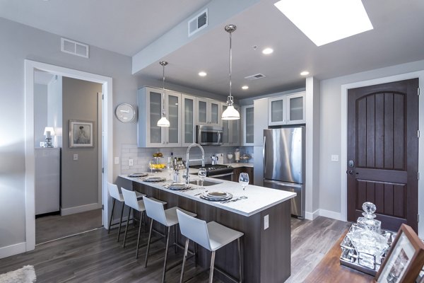 Modern kitchen with stainless steel appliances at 4th West Apartments, a Greystar luxury apartment community