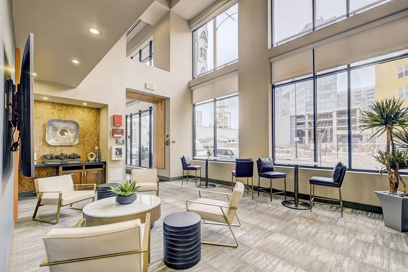 Spacious living room with modern decor and ample natural light at Alara Union Station Apartments