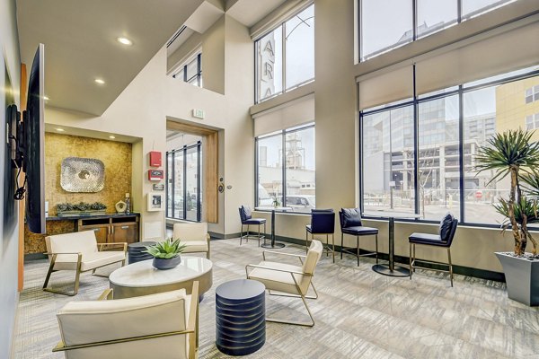 Spacious living room with modern decor and ample natural light at Alara Union Station Apartments