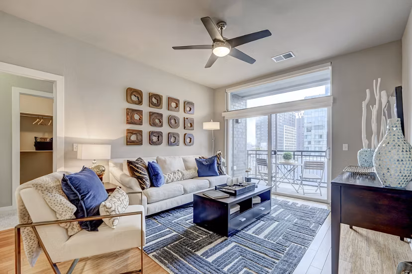 Cozy living room with modern decor and large windows at Alara Union Station Apartments