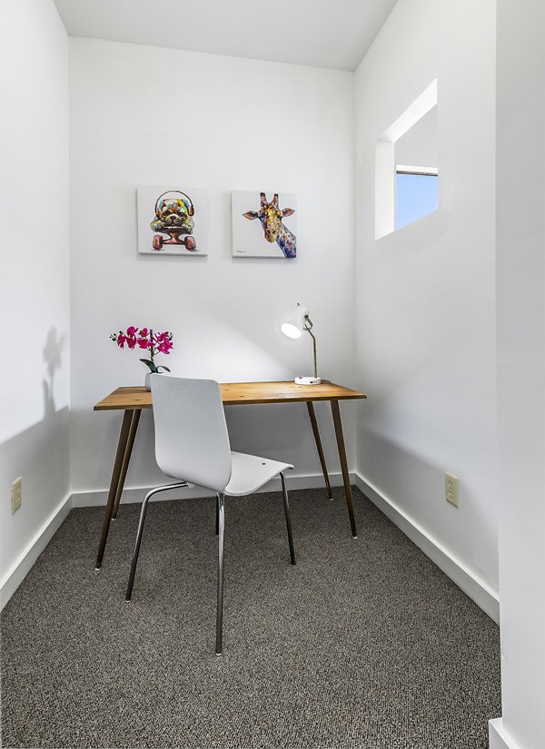 Home office space with modern desk and ergonomic chair at The Court at Dorel Apartments
