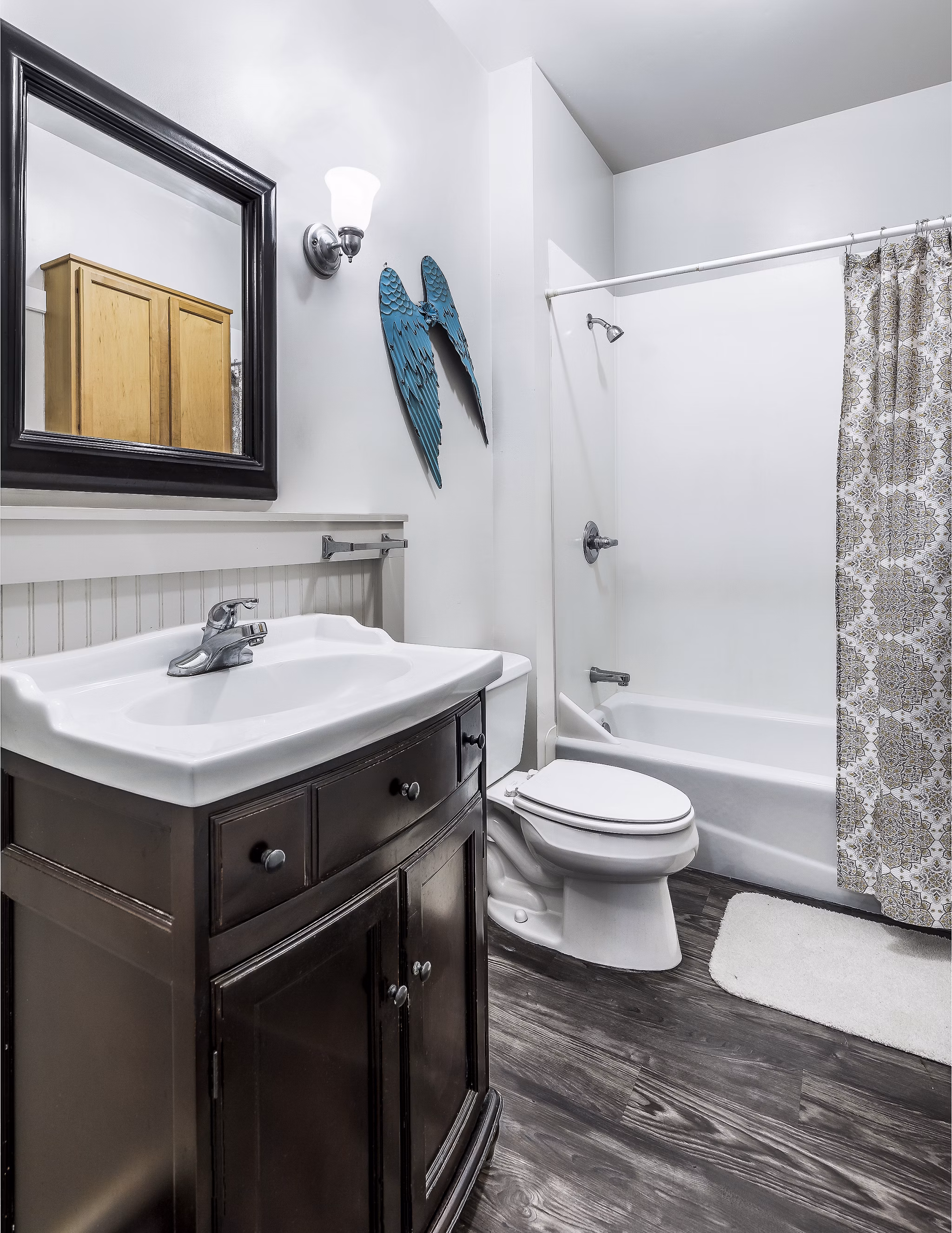 Bathroom featuring modern fixtures and elegant tilework at The Court at Dorel Apartments