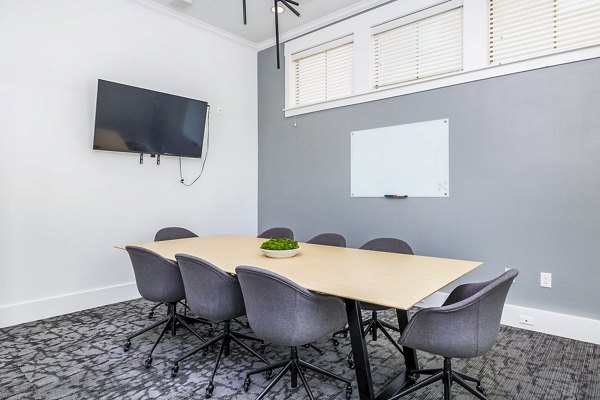 Clubhouse meeting facility with modern furnishings at The Dorel/Girard Court Apartments, ideal for community gatherings and events