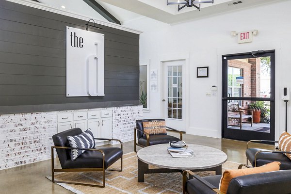 Clubhouse lobby with modern seating and art at The Dorel/Girard Court Apartments