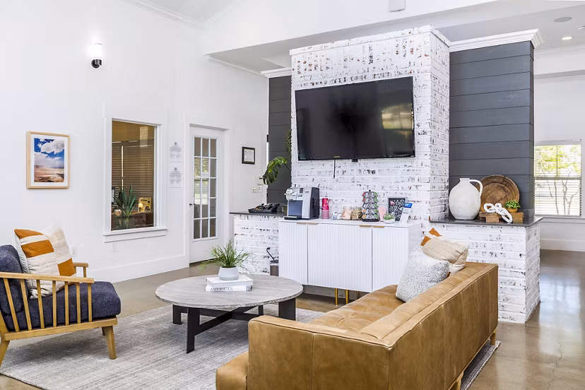 Clubhouse lobby featuring contemporary design and plush seating at The Dorel, Girard Court Apartments
