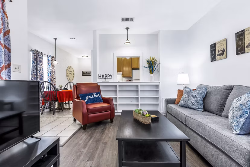 Modern living room with cozy furnishings at The Court at Dorel Apartments, showcasing luxury living
