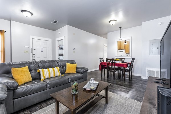 Bright living room with cozy furniture at The Court at Dorel Apartments, featuring modern decor and ample natural light