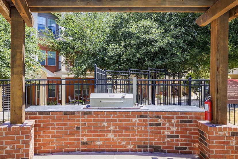 Grill and shaded patio area at The Dorel/Girard Court Apartments
