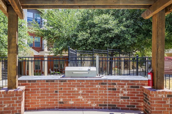 Grill and shaded patio area at The Dorel/Girard Court Apartments
