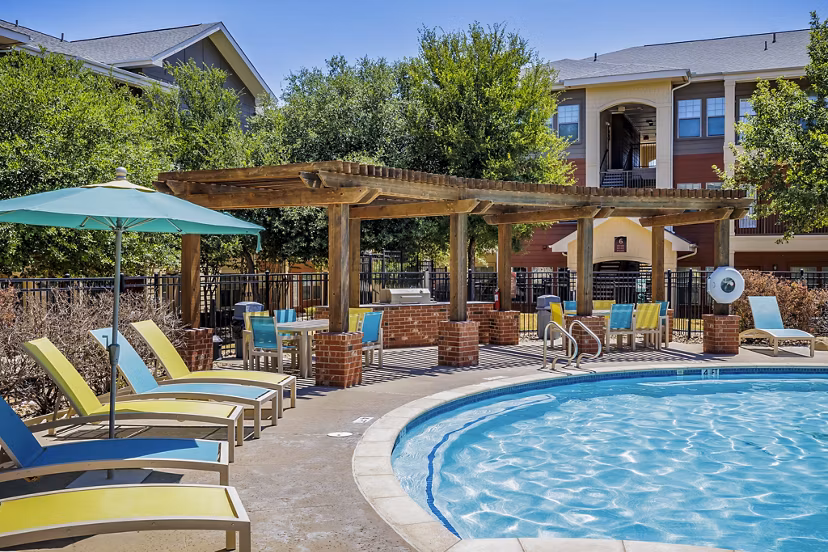 Outdoor patio with grilling stations at The Dorel apartments