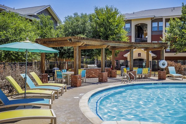 Outdoor patio with grilling stations at The Dorel apartments
