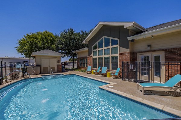 Modern outdoor pool at The Dorel/Girard Court Apartments with landscaped surroundings and spacious lounging area