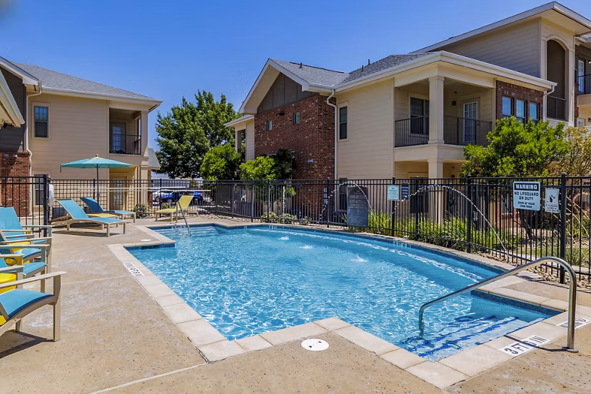 Outdoor pool with lounge chairs at The Dorel/Girard Court Apartments