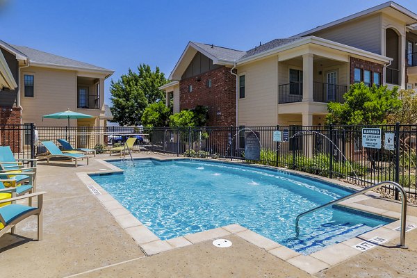Outdoor pool with lounge chairs at The Dorel/Girard Court Apartments