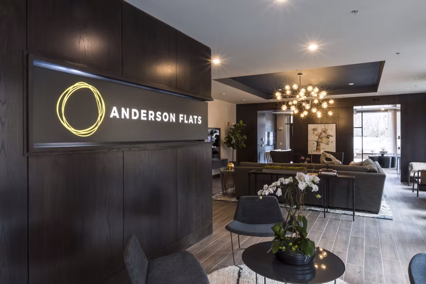 Clubhouse featuring modern design and ample seating at Anderson Flats Apartments