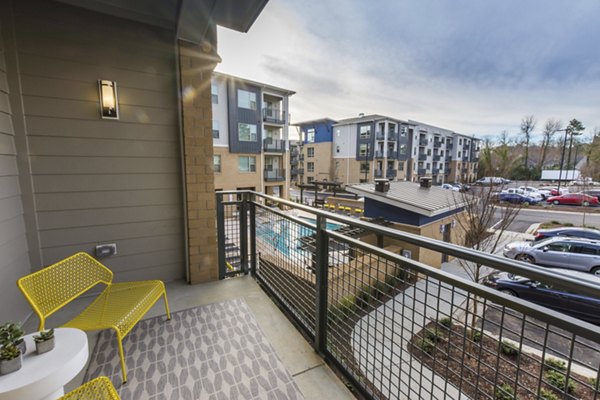 Relaxing patio/balcony space with cozy seating at Anderson Flats Apartments