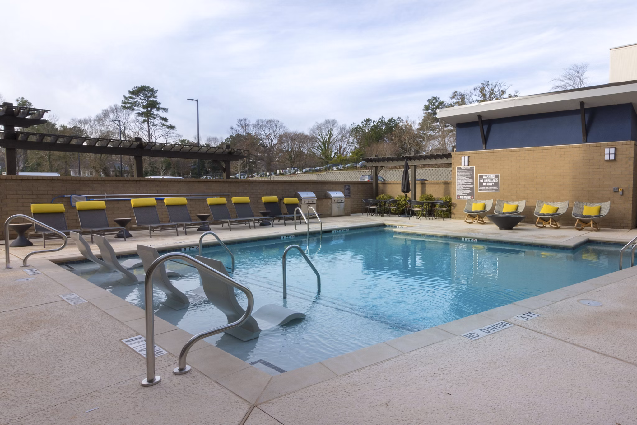 Sparkling outdoor pool at Anderson Flats Apartments, ideal for relaxation and recreation in a luxurious setting