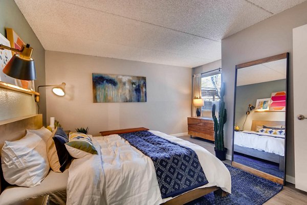 Cozy bedroom with plush bedding and modern design at The Glen at Old Town Apartments