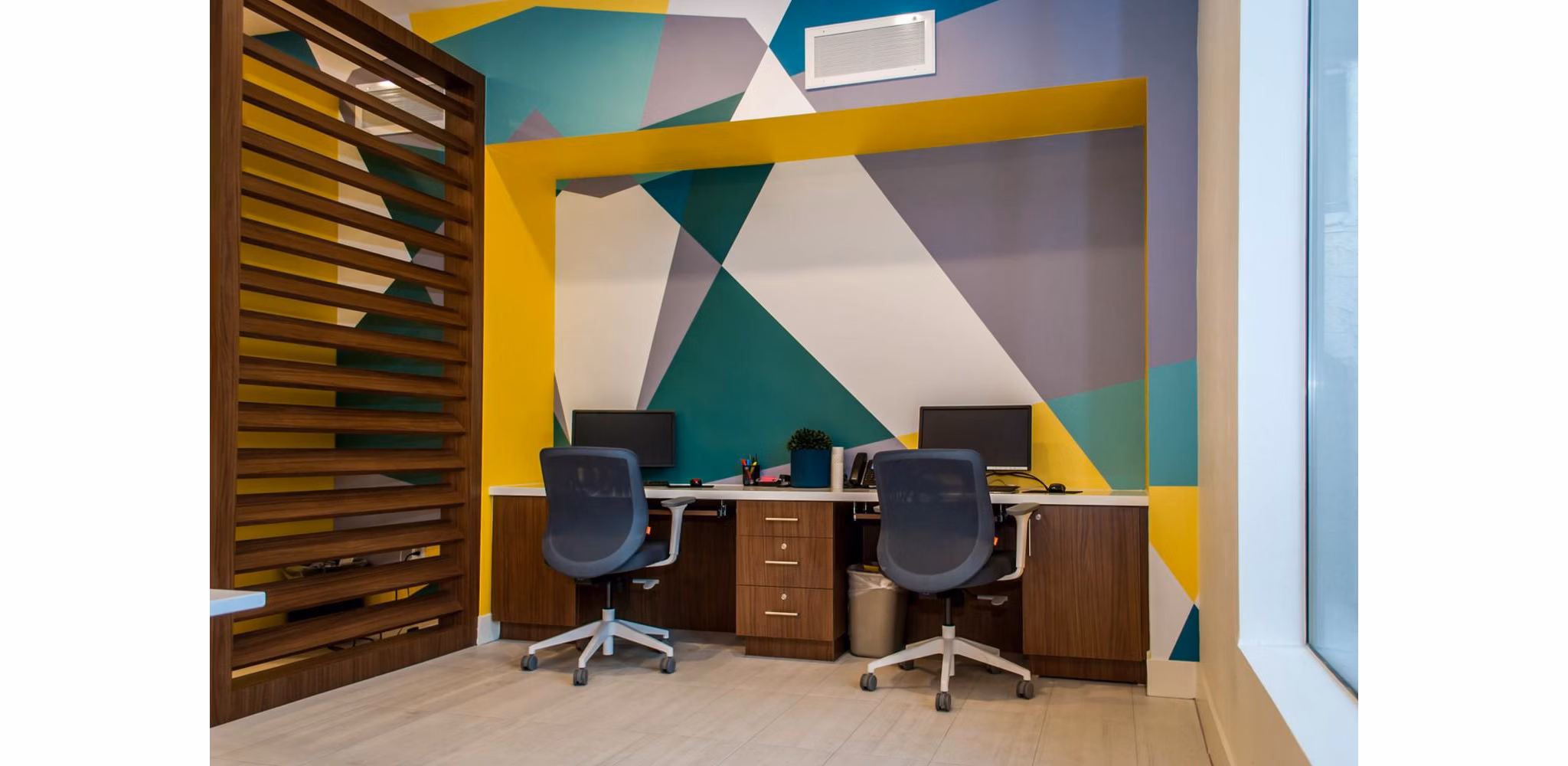 Modern business center at The Glen at Old Town Apartments featuring workstations and meeting spaces for residents
