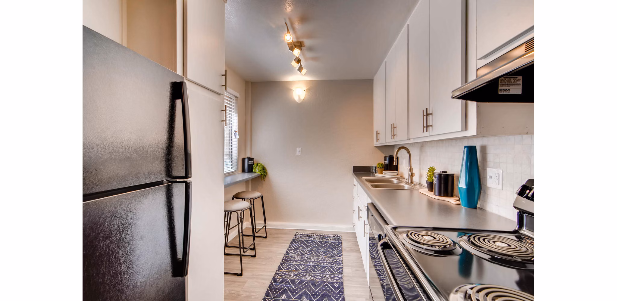 Kitchen featuring modern appliances and granite countertops at The Glen at Old Town Apartments