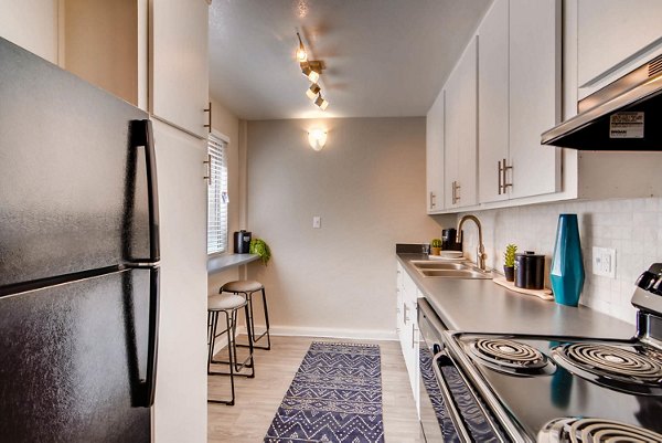 Kitchen featuring modern appliances and granite countertops at The Glen at Old Town Apartments