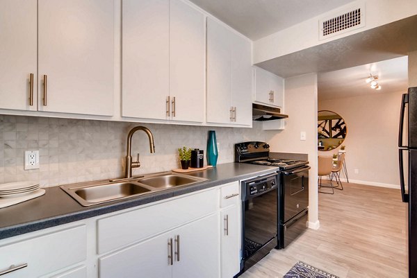 Modern kitchen with stainless steel appliances at The Glen at Old Town Apartments