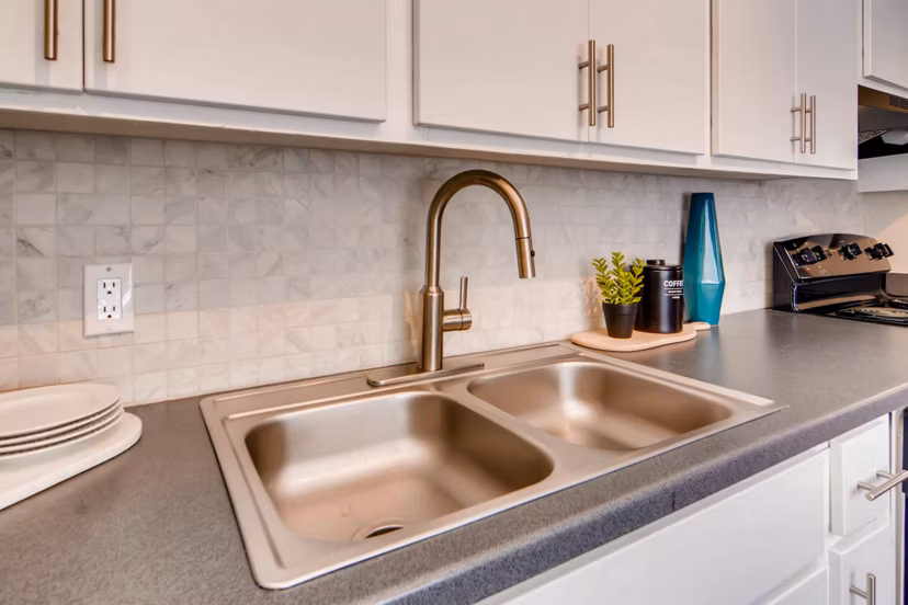 Modern kitchen with stainless steel appliances at The Glen at Old Town Apartments