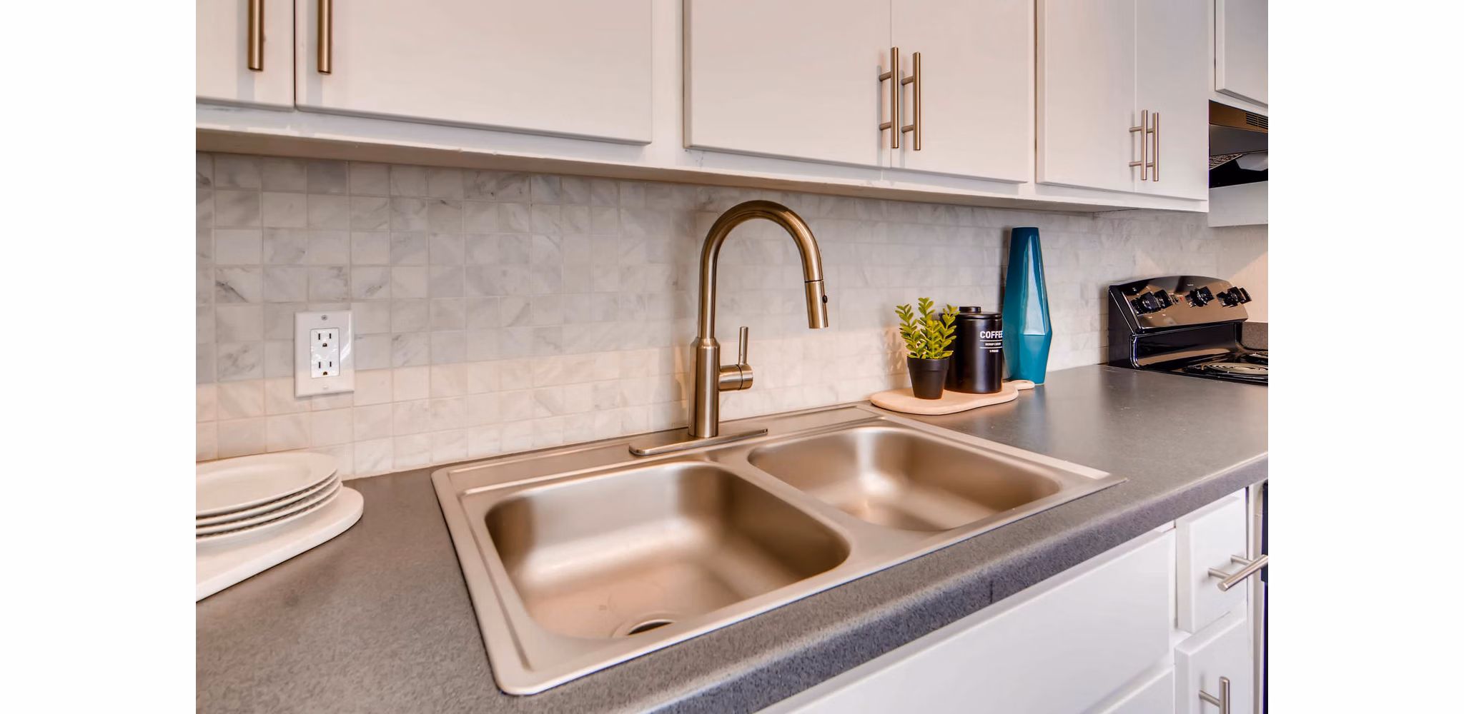 Modern kitchen with stainless steel appliances at The Glen at Old Town Apartments
