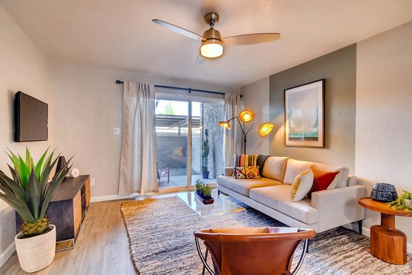 Living room with cozy seating and natural light at The Glen at Old Town Apartments, luxury community by Greystar