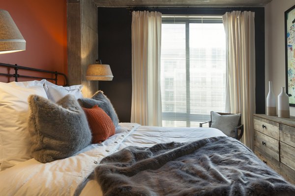 Anthology Apartments: Cozy bedroom with modern decor in luxury high-rise