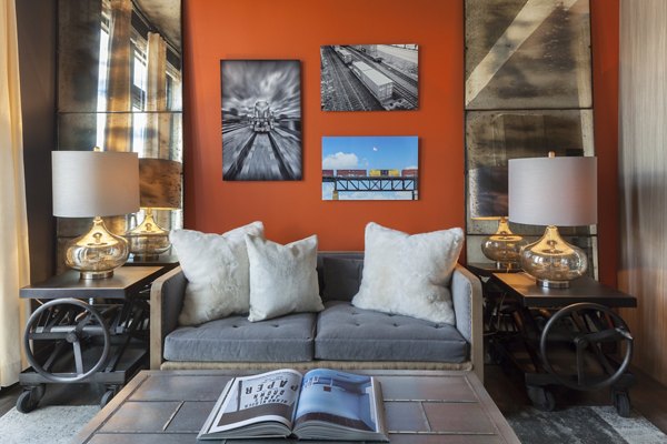 Spacious living room with modern decor at Anthology Apartments, featuring elegant furnishings and ample natural light