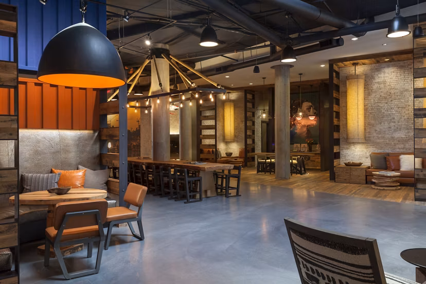 Modern clubhouse with cozy seating and fireplace at Anthology Apartments, a Greystar luxury community