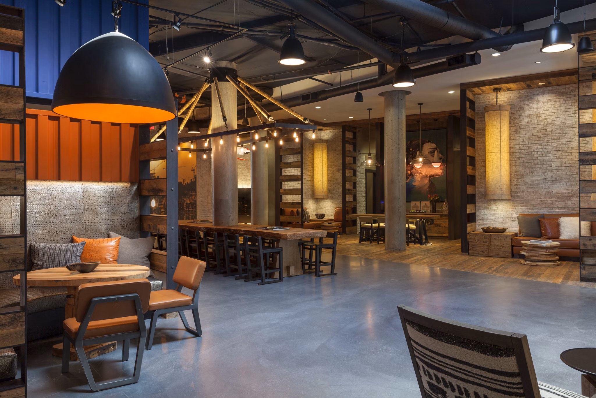 Modern clubhouse with cozy seating and fireplace at Anthology Apartments, a Greystar luxury community