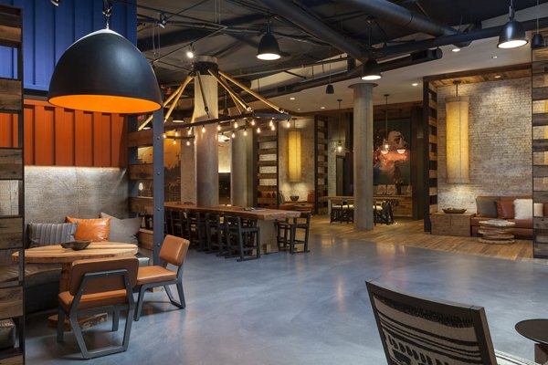 Modern clubhouse with cozy seating and fireplace at Anthology Apartments, a Greystar luxury community