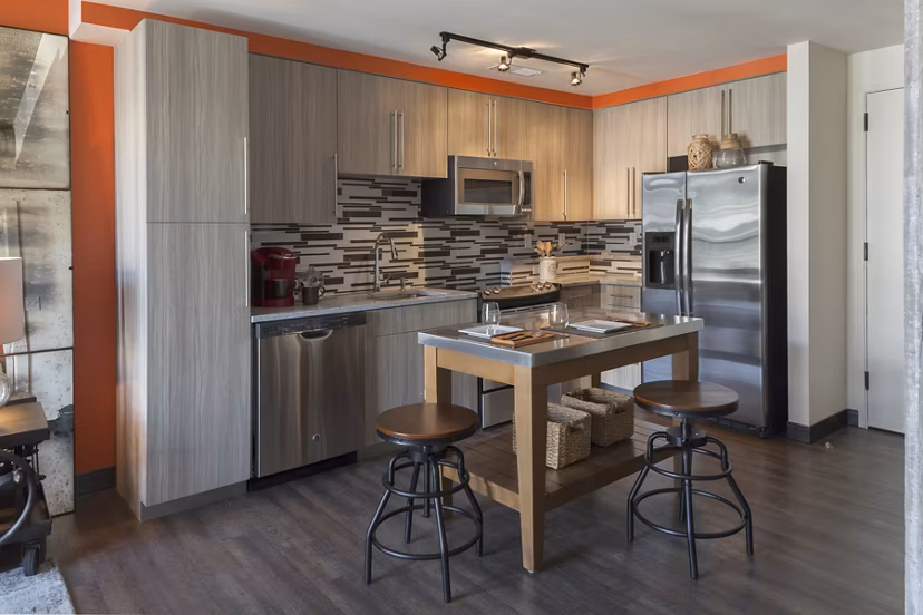Modern kitchen featuring stainless steel appliances and granite countertops at Anthology Apartments in Greystar community