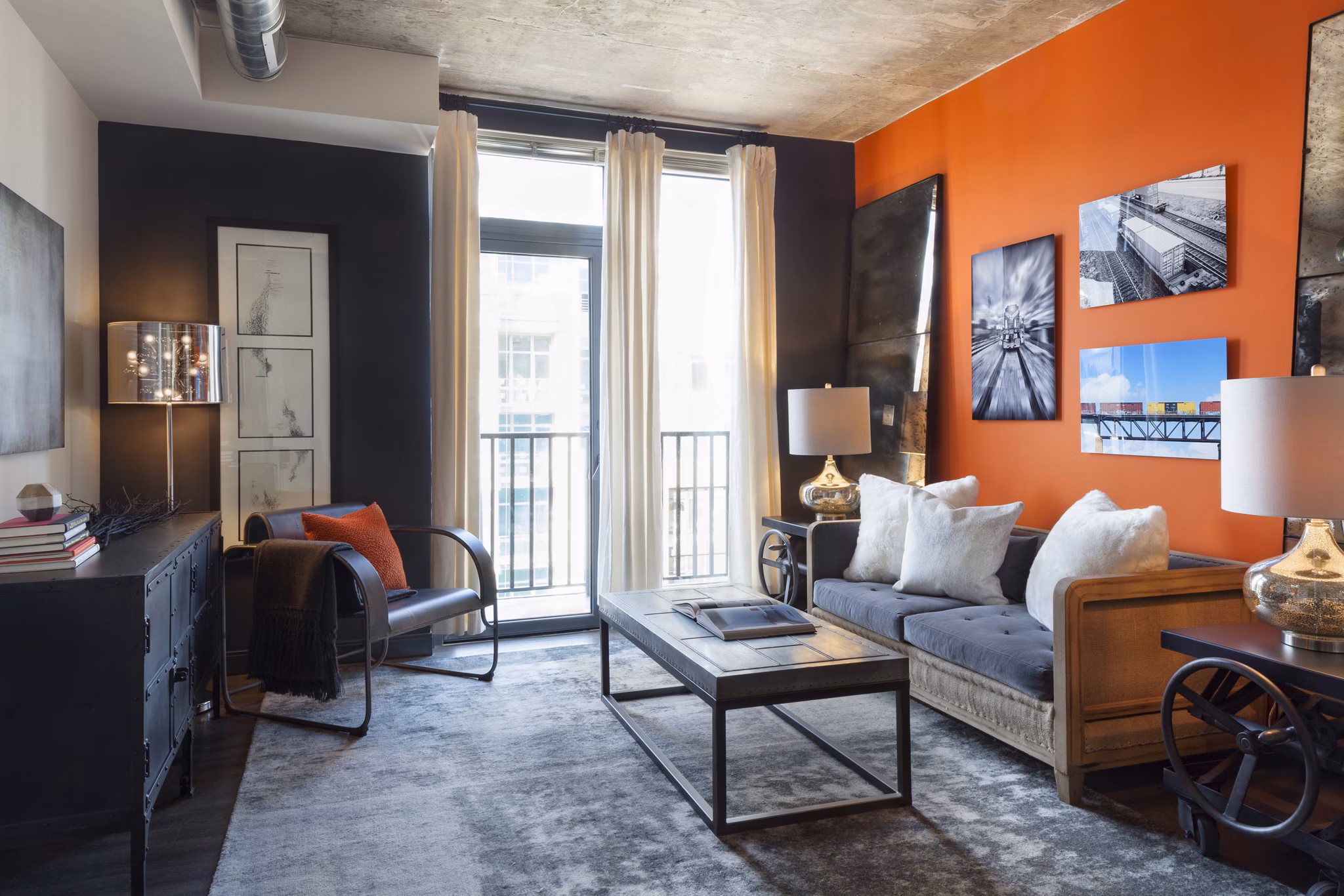 Contemporary living room with stylish decor and natural light at Anthology Apartments