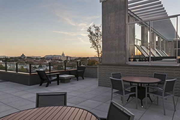 Modern patio area with comfortable seating and lush greenery at Anthology Apartments, ideal for relaxation and social gatherings