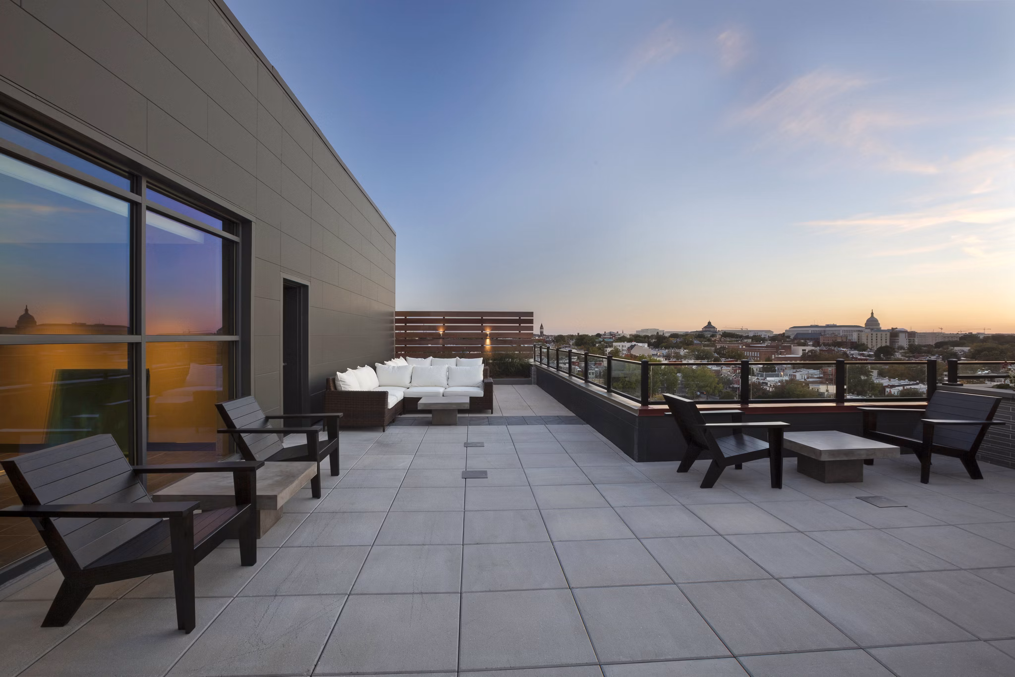 Anthology Apartments: Expansive patio area with modern seating and lush greenery