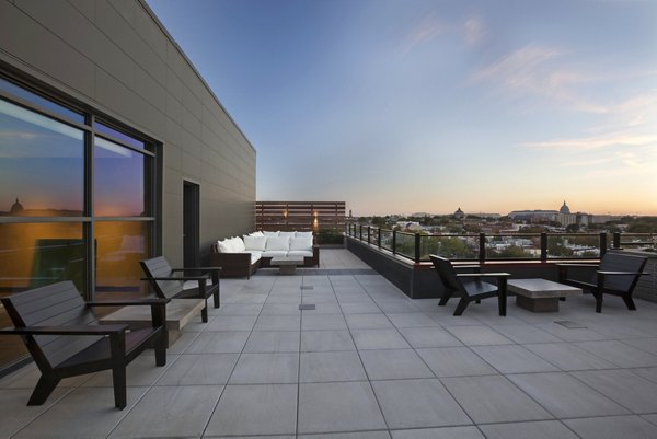 Anthology Apartments: Expansive patio area with modern seating and lush greenery
